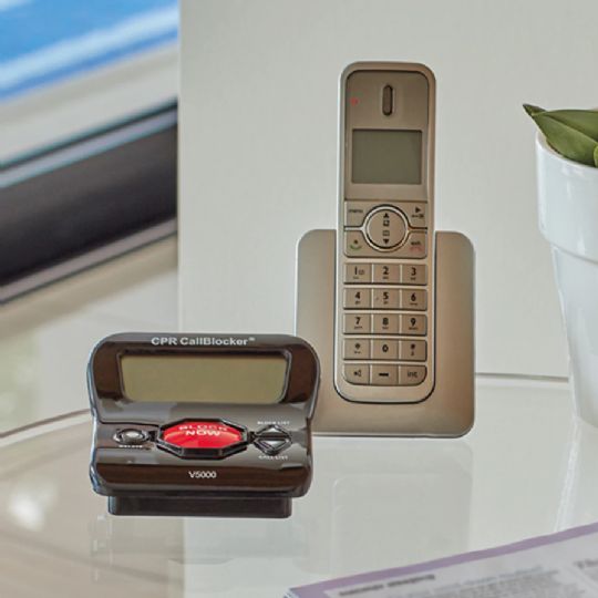 Call Blocker V5000 next to a landline phone as a size reference