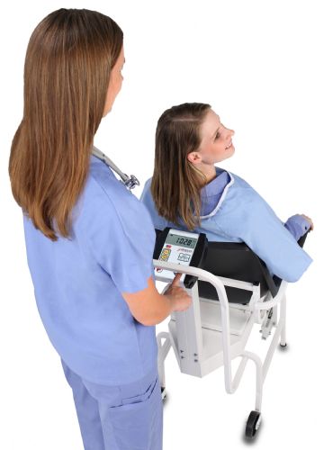 Nurse recording and observing weight measurement with the Detecto Digital Chair Scale