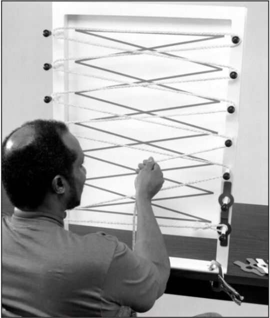 Example of a sequence exercise--a paper backing added behind the frame allows you to draw a sequence out for the patient to follow with string
