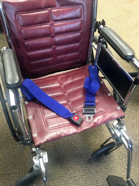 Belt attached to a wheelchair