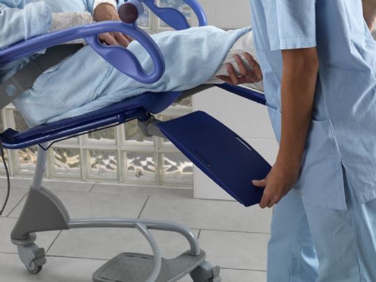 The leg rests swing out of the way during transfers and then automatically adjust to the most ergonomic position for the patient when in use